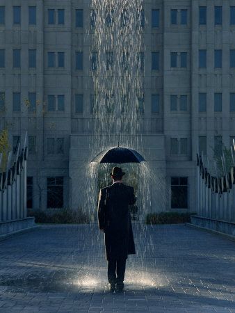 Man with umbrella under a regional rain by Joseph Hancock